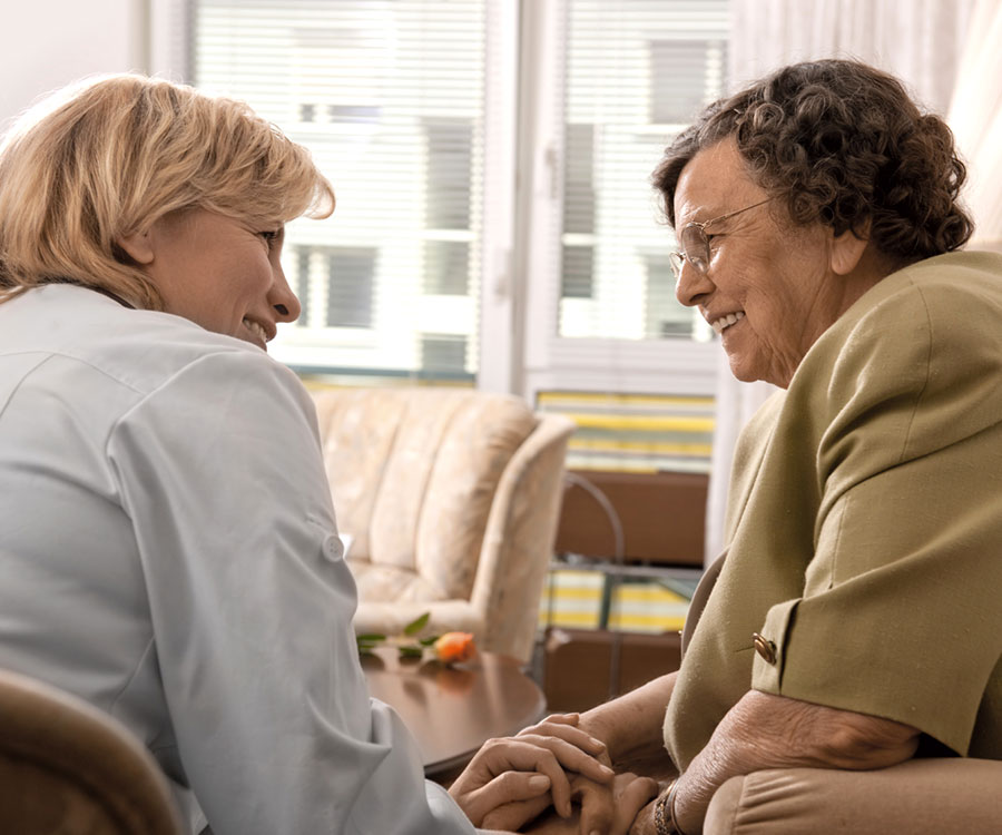 two people sitting and smiling at each other