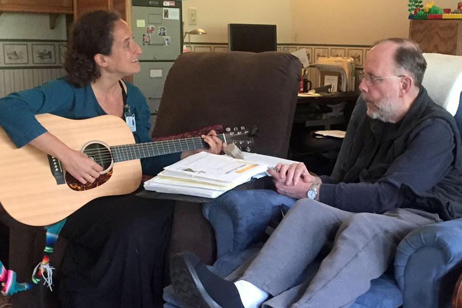 guitar player playing music for a patient