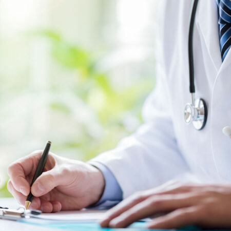 doctor writing on a document