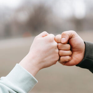 two people bumping fists