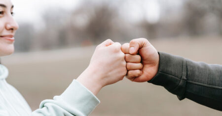 two people bumping fists