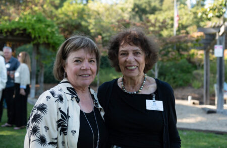 two people smiling outdoors