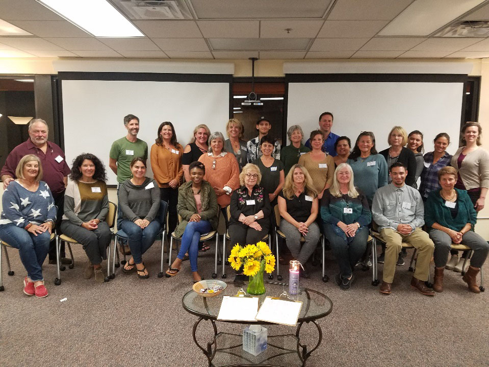 group of people sitting in a meeting room for a photo shoot