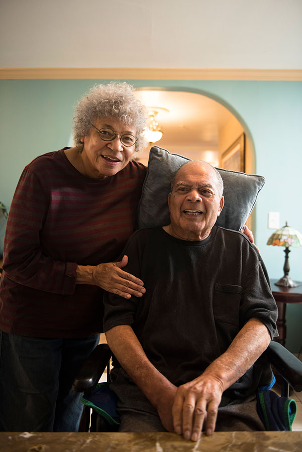 elderly couple smiling in their house
