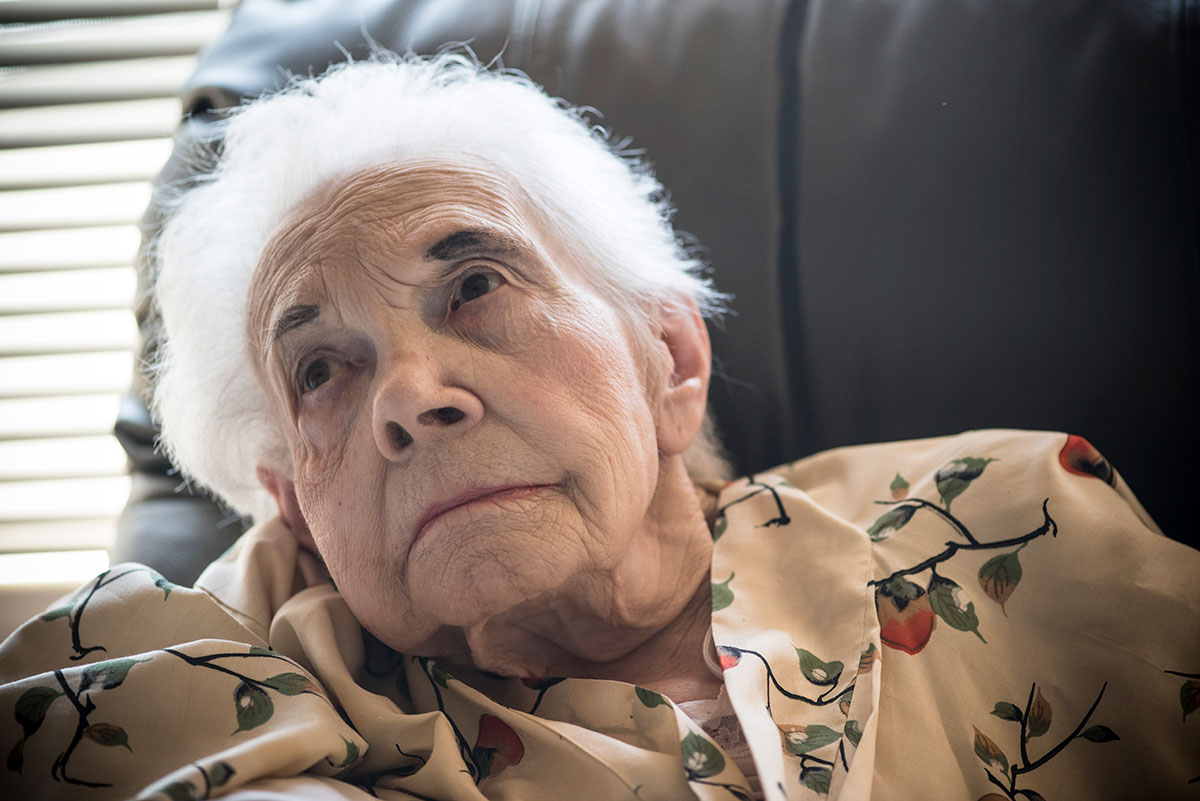closeup of elderly person sitting in chair