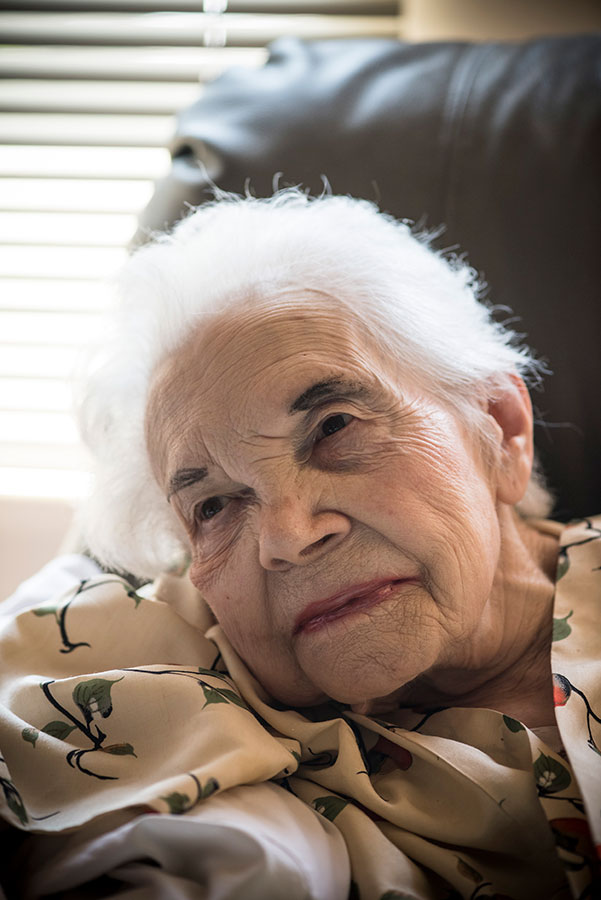 closeup of elderly person sitting in chair smiling