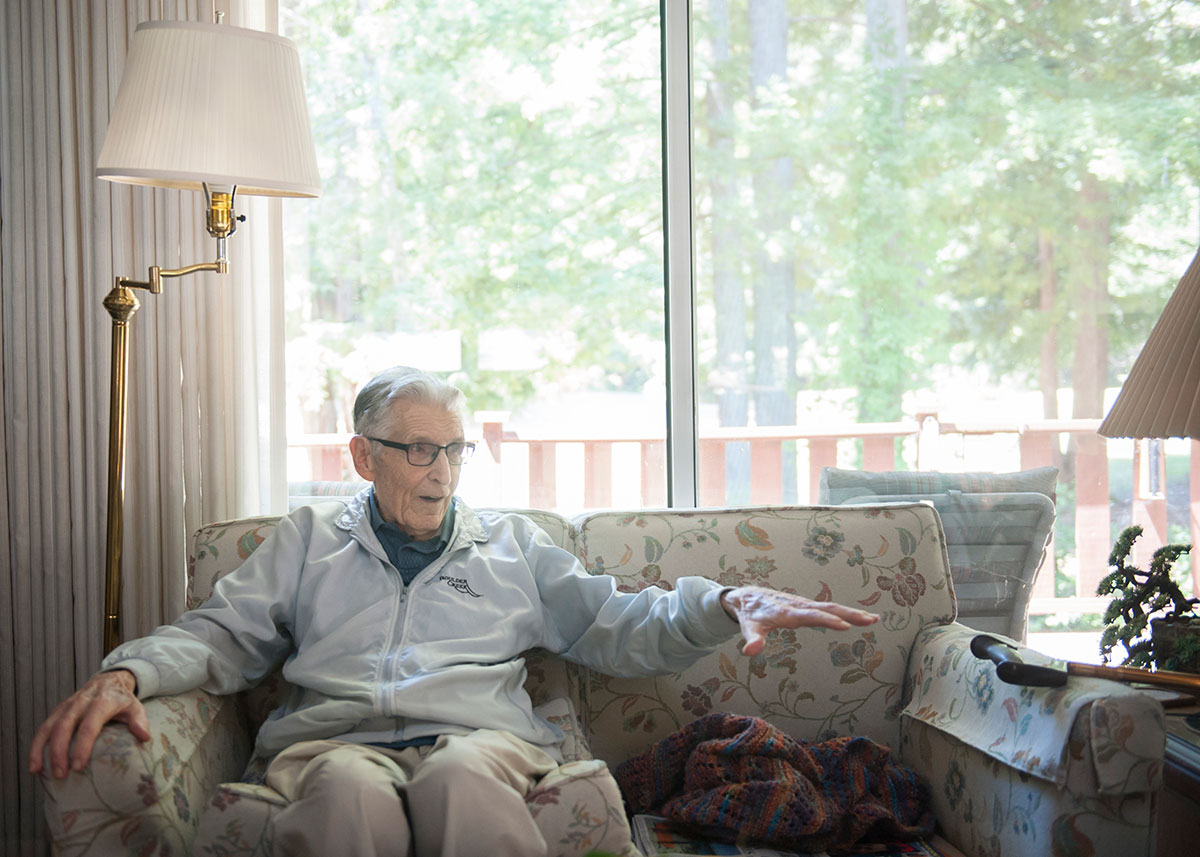 elderly person sitting on a couch and talking