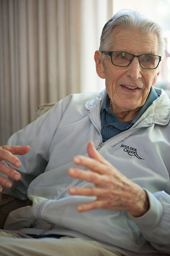 elderly person sitting on a couch talking