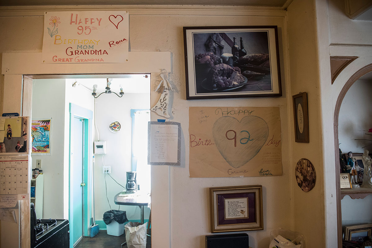 wall inside a house with photos and birthday wishes on the wall