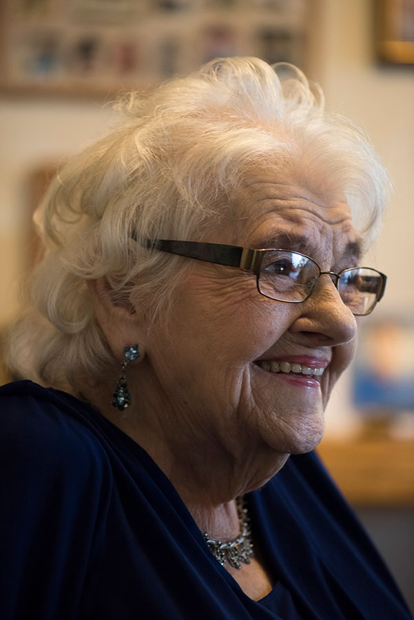 elderly person sitting in a house smiling