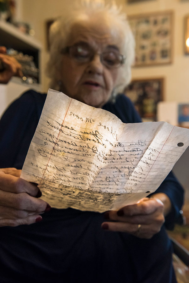 elderly person reading a handwritten note