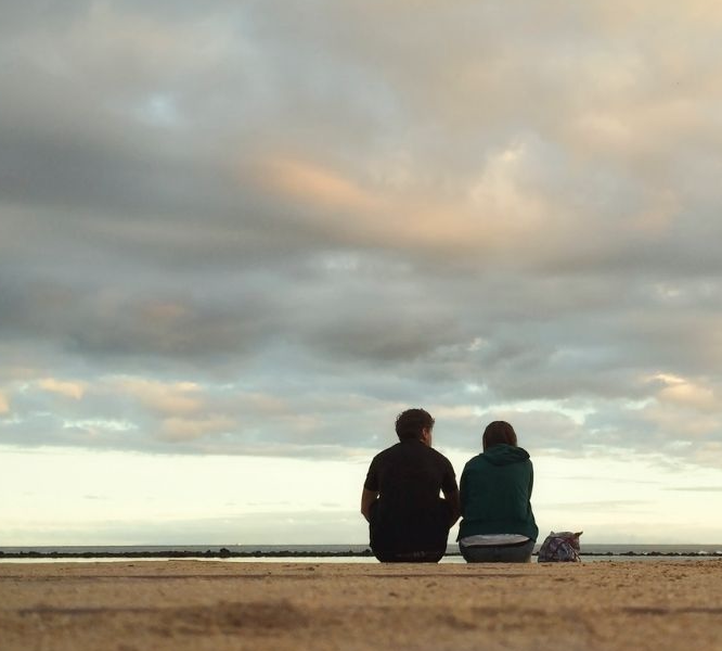 Couple Sitting on Beach